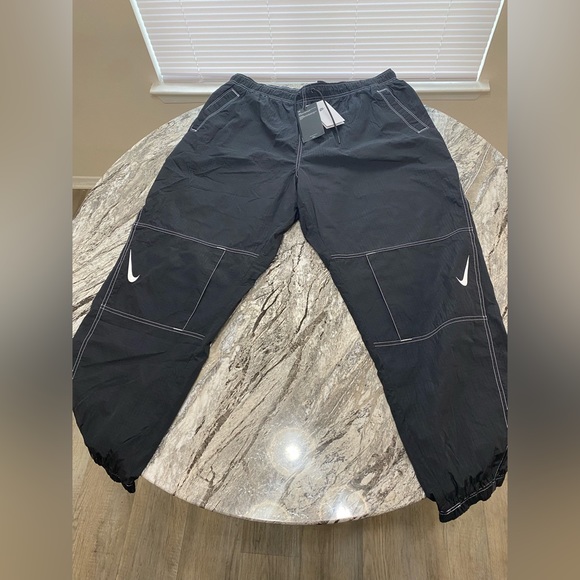 Nike Pants & Jumpsuits Nike Swoosh Pack Repel Woven Cuffed Pants In